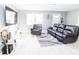 Bright living room features a large sectional sofa and a cozy recliner at 8114 N Edison Ave, Tampa, FL 33604