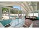 Screened porch with seating, overlooking the pool at 8212 Forest Cir, Seminole, FL 33776