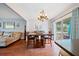 Dining room with hardwood floors, chandelier, and view of living room at 8212 Forest Cir, Seminole, FL 33776