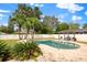 Kidney-shaped pool with a pergola and lounge chairs in the backyard at 8212 Forest Cir, Seminole, FL 33776