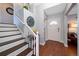 Bright entryway with hardwood floors, staircase, and coat closet at 8212 Forest Cir, Seminole, FL 33776