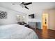 King bedroom with hardwood floors, walk-in closet, and dresser at 8212 Forest Cir, Seminole, FL 33776