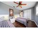 Bedroom with two twin beds, hardwood floors, and ceiling fan at 8212 Forest Cir, Seminole, FL 33776