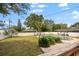 Landscaped backyard with a kidney-shaped pool and wooden deck at 8212 Forest Cir, Seminole, FL 33776