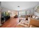 Hardwood floor living room with sectional sofa and large TV at 8212 Forest Cir, Seminole, FL 33776