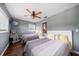 Bedroom with two twin beds, hardwood floors, and ceiling fan at 8212 Forest Cir, Seminole, FL 33776
