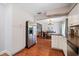 Kitchen with white cabinets, stainless steel appliances, and view of dining area at 8212 Forest Cir, Seminole, FL 33776