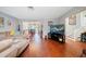 Spacious living room with hardwood floors, sectional sofa, and large TV at 8212 Forest Cir, Seminole, FL 33776
