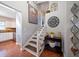 Staircase with white railing, wall art, and console table at 8212 Forest Cir, Seminole, FL 33776