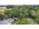 Overhead view of the property surrounded by mature trees and fenced yards at 733 1/2 New Jersey St, Clearwater, FL 33756