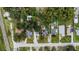 Overhead shot features the home with lush landscaping, other homes, and nearby neighborhood pool at 733 1/2 New Jersey St, Clearwater, FL 33756