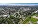 Expansive aerial view showcases the home's neighborhood, proximity to water, and surrounding mature trees at 733 1/2 New Jersey St, Clearwater, FL 33756