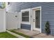 Backyard entrance featuring white fence, door, and well maintained turf at 733 1/2 New Jersey St, Clearwater, FL 33756