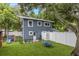 A house with a fenced backyard, synthetic grass, tree swing and small pet fence at 733 1/2 New Jersey St, Clearwater, FL 33756