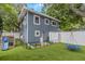 View of the fenced-in backyard with play set and blue swing hanging from tree at 733 1/2 New Jersey St, Clearwater, FL 33756