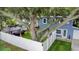 Aerial view of a fenced backyard with lush grass, a gazebo, and a tree swing at 733 1/2 New Jersey St, Clearwater, FL 33756