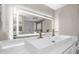 Sleek bathroom featuring a modern sink, illuminated mirror, and laundry facilities at 733 1/2 New Jersey St, Clearwater, FL 33756