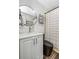 Updated bathroom with gray vanity, modern faucet, and a tub/shower with a striped curtain at 733 1/2 New Jersey St, Clearwater, FL 33756