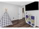 Well-lit bedroom featuring a large television and built in bookcase at 733 1/2 New Jersey St, Clearwater, FL 33756