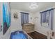 Bedroom with wood floors, crib, changing table, and natural light from the window at 733 1/2 New Jersey St, Clearwater, FL 33756