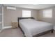 Neutral-toned bedroom featuring a comfortable queen bed, accent lighting, and a mini-split at 733 1/2 New Jersey St, Clearwater, FL 33756