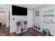 The bedroom has a TV, a toy keyboard and dark wood floors at 733 1/2 New Jersey St, Clearwater, FL 33756