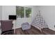 Comfortable room featuring wood floors, a tipi and a lounge chair at 733 1/2 New Jersey St, Clearwater, FL 33756