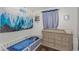 Bedroom with wood floors, crib, changing table, and nature-themed decor on the walls at 733 1/2 New Jersey St, Clearwater, FL 33756