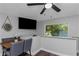 Cozy dining area with a modern fan, large TV and natural light from the window at 733 1/2 New Jersey St, Clearwater, FL 33756