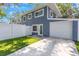 Charming two-story home with a well-manicured lawn and a white fence at 733 1/2 New Jersey St, Clearwater, FL 33756