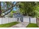 Charming two-story home with a well-manicured lawn and a white fence at 733 1/2 New Jersey St, Clearwater, FL 33756