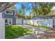 Charming two-story home with a well-manicured lawn and a white fence at 733 1/2 New Jersey St, Clearwater, FL 33756