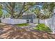 Charming two-story home with a well-manicured lawn and a white fence at 733 1/2 New Jersey St, Clearwater, FL 33756