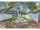 Charming two-story home with a well-manicured lawn and a white fence at 733 1/2 New Jersey St, Clearwater, FL 33756