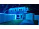 Night view of the charming house with lit fence and green lawn at 733 1/2 New Jersey St, Clearwater, FL 33756