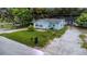 Charming, light blue, single-Gathering home, with mature trees, and a well kept front yard and driveway at 733 1/2 New Jersey St, Clearwater, FL 33756
