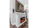 Cozy fireplace with white brick surround and a painting of a sailboat on the wall creates a relaxing ambiance at 733 1/2 New Jersey St, Clearwater, FL 33756