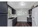 Updated kitchen features navy cabinets, white countertops, black sink, and stainless steel appliances at 733 1/2 New Jersey St, Clearwater, FL 33756