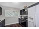 This kitchen features updated appliances, granite counters, navy cabinets, and bright windows at 733 1/2 New Jersey St, Clearwater, FL 33756