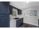 Charming kitchen with navy cabinets, modern countertops, updated sink, and natural light from windows at 733 1/2 New Jersey St, Clearwater, FL 33756