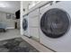 Modern laundry area near the bedroom featuring a stacked washer-dryer unit at 733 1/2 New Jersey St, Clearwater, FL 33756
