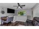 Inviting dining and living area with dark floors, fan, and large windows providing an airy and bright feel at 733 1/2 New Jersey St, Clearwater, FL 33756