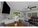 Inviting dining and living area with dark floors, fan, and large windows providing an airy and bright feel at 733 1/2 New Jersey St, Clearwater, FL 33756