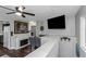 Open-concept living room features a fireplace, dining area, and a large flat screen television at 733 1/2 New Jersey St, Clearwater, FL 33756
