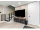 Cozy living room featuring modern media center with stairs to the second floor at 733 1/2 New Jersey St, Clearwater, FL 33756