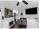Open-concept living room features a fireplace, dining area, and a large flat screen television at 733 1/2 New Jersey St, Clearwater, FL 33756
