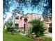 Two story house with peach colored exterior and landscaping at 14913 Berkford Ave, Tampa, FL 33625