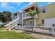 Two-story building with balconies, white picket fence, and green lawn at 105 Pompano Se Dr # A, St Petersburg, FL 33705