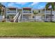 Front view of a charming yellow building with balconies and a grassy area at 105 Pompano Se Dr # A, St Petersburg, FL 33705
