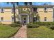 Building exterior showing landscaped grounds and walkway at 105 Pompano Se Dr # A, St Petersburg, FL 33705